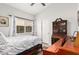 A cozy room with a queen-sized bed with a floral print and a piano at 4013 E Woodland Dr, Phoenix, AZ 85048