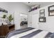 Bedroom featuring decorative wall hangings, with a view of a living space through double doors at 4013 E Woodland Dr, Phoenix, AZ 85048