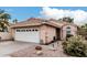 Charming single-story home featuring a two-car garage, tile roof and low maintenance landscaping at 4013 E Woodland Dr, Phoenix, AZ 85048