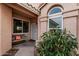 Inviting front porch with a seating area and security door, complemented by desert landscaping at 4013 E Woodland Dr, Phoenix, AZ 85048