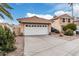 Exterior view of a home showcasing a two-car garage, desert landscaping and neutral color scheme at 4013 E Woodland Dr, Phoenix, AZ 85048