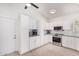 Modern kitchen featuring white cabinetry, stainless steel appliances, and updated countertops at 4013 E Woodland Dr, Phoenix, AZ 85048
