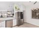 Bright kitchen featuring stainless steel appliances and granite countertops overlooking the living area at 4013 E Woodland Dr, Phoenix, AZ 85048