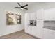 Bright kitchen with white cabinets, granite countertops and lemon print curtains at 4013 E Woodland Dr, Phoenix, AZ 85048