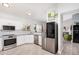 Bright, updated kitchen with white cabinets, stainless steel appliances, and granite countertops at 4013 E Woodland Dr, Phoenix, AZ 85048