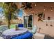 Cozy covered patio featuring ample seating, lovely plants, lighting, and privacy for outdoor enjoyment at 4013 E Woodland Dr, Phoenix, AZ 85048