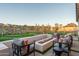 Relaxing outdoor area with fire pit, comfortable seating, and putting green at 43720 N Acadia Way, New River, AZ 85087