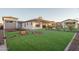 Expansive backyard featuring manicured lawn and well-maintained landscaping at 43720 N Acadia Way, New River, AZ 85087