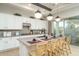 Bright kitchen features white cabinets, sleek countertops, and a large island with seating at 43720 N Acadia Way, New River, AZ 85087