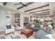Open-concept living room featuring an expansive sofa, modern decor, and an adjacent kitchen at 43720 N Acadia Way, New River, AZ 85087