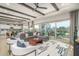 Spacious living room with vaulted ceilings, expansive windows, and stylish contemporary decor and furniture at 43720 N Acadia Way, New River, AZ 85087