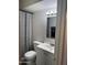 The bathroom includes a vanity with a sink, toilet, and shower with curtain at 4537 N 26Th Dr, Phoenix, AZ 85017