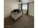 This carpeted bedroom features a ceiling fan and space for a desk or sitting area at 4537 N 26Th Dr, Phoenix, AZ 85017