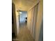 Hallway leading to the living room showcases wood-look floors and neutral decor at 4537 N 26Th Dr, Phoenix, AZ 85017