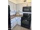 Classic kitchen with white cabinets, black appliances, granite countertops, and wood-look floors at 4537 N 26Th Dr, Phoenix, AZ 85017