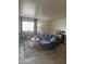 Bright living room with sectional sofa, modern decor, large window, and wood-look floors at 4537 N 26Th Dr, Phoenix, AZ 85017