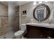 Cozy bathroom featuring a tiled shower, vanity sink, and decorative mirror at 4610 N 68Th St # 421, Scottsdale, AZ 85251