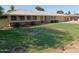Charming single-level home featuring a manicured lawn, brick accents, and attached two car garage at 4909 E Osborn Rd, Phoenix, AZ 85018