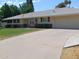 Inviting single-level home with a long driveway leading to an attached two car garage at 4909 E Osborn Rd, Phoenix, AZ 85018