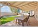 Outdoor dining area with a covered patio overlooking a pool and grassy backyard at 5047 W Chicago S Cir, Chandler, AZ 85226