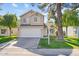 Charming two-story home with a well-maintained lawn, mature trees, and a two-car garage at 5047 W Chicago S Cir, Chandler, AZ 85226