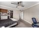 Neutral bedroom featuring carpet, a ceiling fan, a closet with many shelves and a blue desk chair at 6236 N 16Th St # 15, Phoenix, AZ 85016