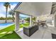 Inviting covered patio with lounge seating, outdoor dining, barbecue, and a pool overlooking the backyard at 6525 N 83Rd St, Scottsdale, AZ 85250