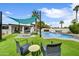 A perfect backyard featuring a large swimming pool, chairs and lounge chairs with a sunshade at 6525 N 83Rd St, Scottsdale, AZ 85250