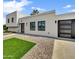 Stylish home featuring clean architectural lines, desert landscaping, and an attached garage at 6525 N 83Rd St, Scottsdale, AZ 85250