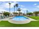 Backyard oasis with a sparkling pool, lush landscaping, and comfortable seating area at 6525 N 83Rd St, Scottsdale, AZ 85250
