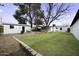 Large backyard featuring grass, decorative rocks, mature tree, and shed at 676 N 6Th Pl, Coolidge, AZ 85128