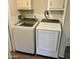 A laundry room featuring a modern, white Samsung washer and dryer with matching cabinets above at 7300 N 51St Ave # B245, Glendale, AZ 85301