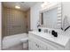 Updated bathroom featuring a modern vanity, patterned tile accent wall and shower at 7650 E Mariposa Dr, Scottsdale, AZ 85251