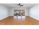 Bright living room featuring wood flooring, a ceiling fan, and sliding glass doors at 7650 E Mariposa Dr, Scottsdale, AZ 85251