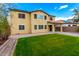 Expansive backyard with lush green grass, a paved patio, and mature trees offering ample space for recreation at 7975 W Andrea Dr, Peoria, AZ 85383