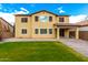 Spacious backyard featuring a covered patio and well-maintained lawn, perfect for outdoor living and entertaining at 7975 W Andrea Dr, Peoria, AZ 85383