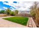 Backyard featuring well-kept lawn and a charming stone pathway, creating a serene and inviting outdoor space at 7975 W Andrea Dr, Peoria, AZ 85383