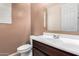 Bathroom featuring a white sink, dark vanity, and a large mirror at 7975 W Andrea Dr, Peoria, AZ 85383