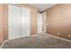 Cozy bedroom featuring carpeted floors and a double door closet for ample storage space at 7975 W Andrea Dr, Peoria, AZ 85383