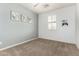 Light-filled bedroom with modern décor, neutral carpet, and a shuttered window at 7975 W Andrea Dr, Peoria, AZ 85383