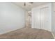 Bright bedroom with neutral carpet, closet, and doorways to other rooms at 7975 W Andrea Dr, Peoria, AZ 85383