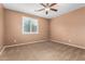 Bedroom features carpeted floors, a ceiling fan, and a window that allows plenty of natural light at 7975 W Andrea Dr, Peoria, AZ 85383
