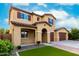 Attractive home with a three-car garage, manicured lawn and stone accents at 7975 W Andrea Dr, Peoria, AZ 85383