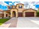 Two-story home showcasing a stucco facade, tile roof, and a three-car garage with driveway at 7975 W Andrea Dr, Peoria, AZ 85383