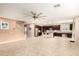 Open-concept kitchen with stainless steel appliances, center island, and seamless flow to the living area at 7975 W Andrea Dr, Peoria, AZ 85383