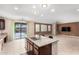 Bright kitchen featuring a large island, granite countertops, stainless steel appliances, and access to the patio at 7975 W Andrea Dr, Peoria, AZ 85383