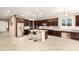 Modern kitchen with stainless appliances, granite counters, dark wood cabinets, and tile floors at 7975 W Andrea Dr, Peoria, AZ 85383
