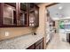 Gourmet kitchen featuring granite countertops, stainless steel appliances, and custom cabinetry at 7975 W Andrea Dr, Peoria, AZ 85383