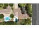 An aerial view shows a backyard pool, mature landscaping, and a well-maintained home near a road at 8002 N 5Th Ave, Phoenix, AZ 85021