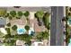 The aerial view showcases mature landscaping, backyard pools, well-maintained homes, and a nearby street at 8002 N 5Th Ave, Phoenix, AZ 85021